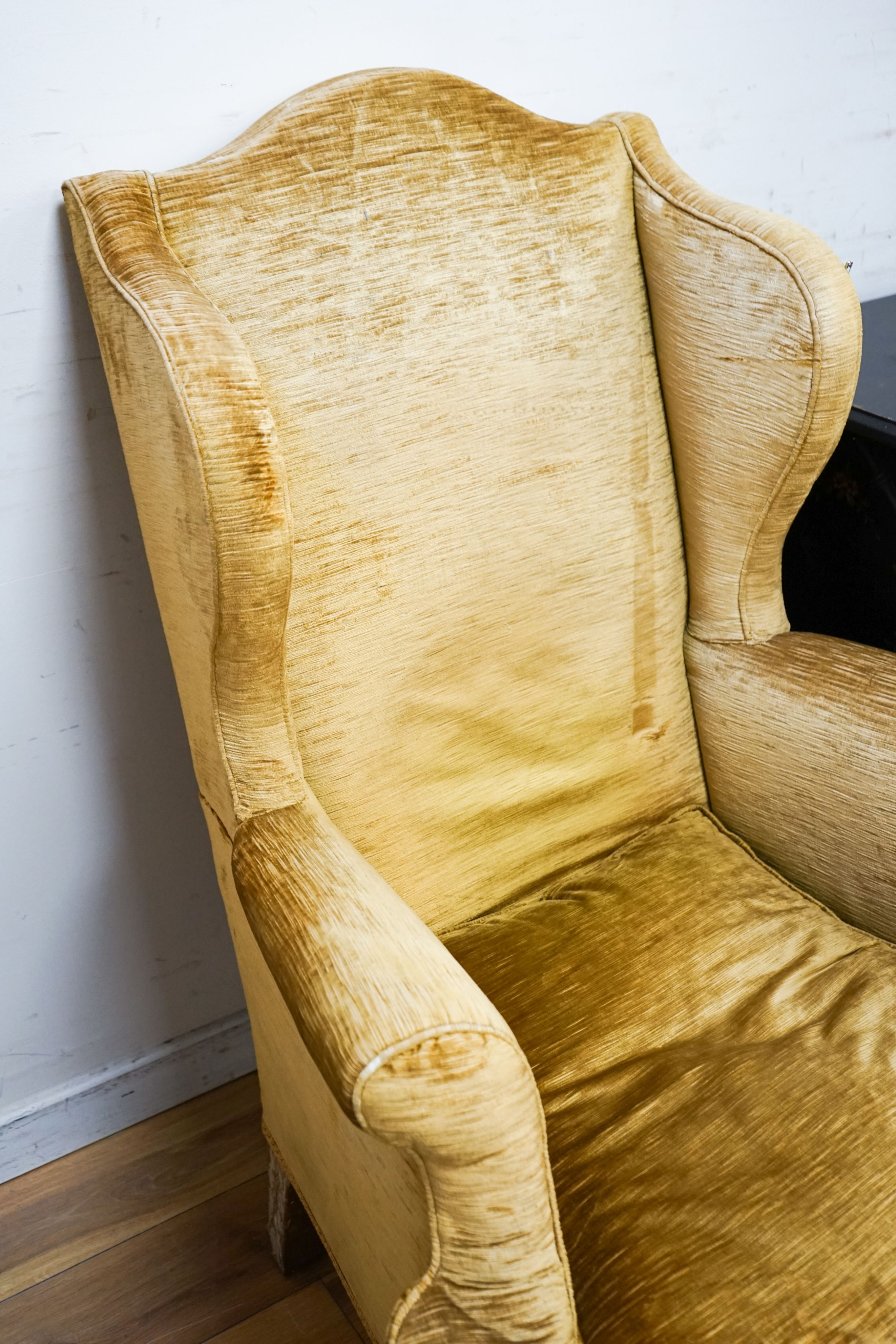 A Chippendale style gold velvet wing backed chair